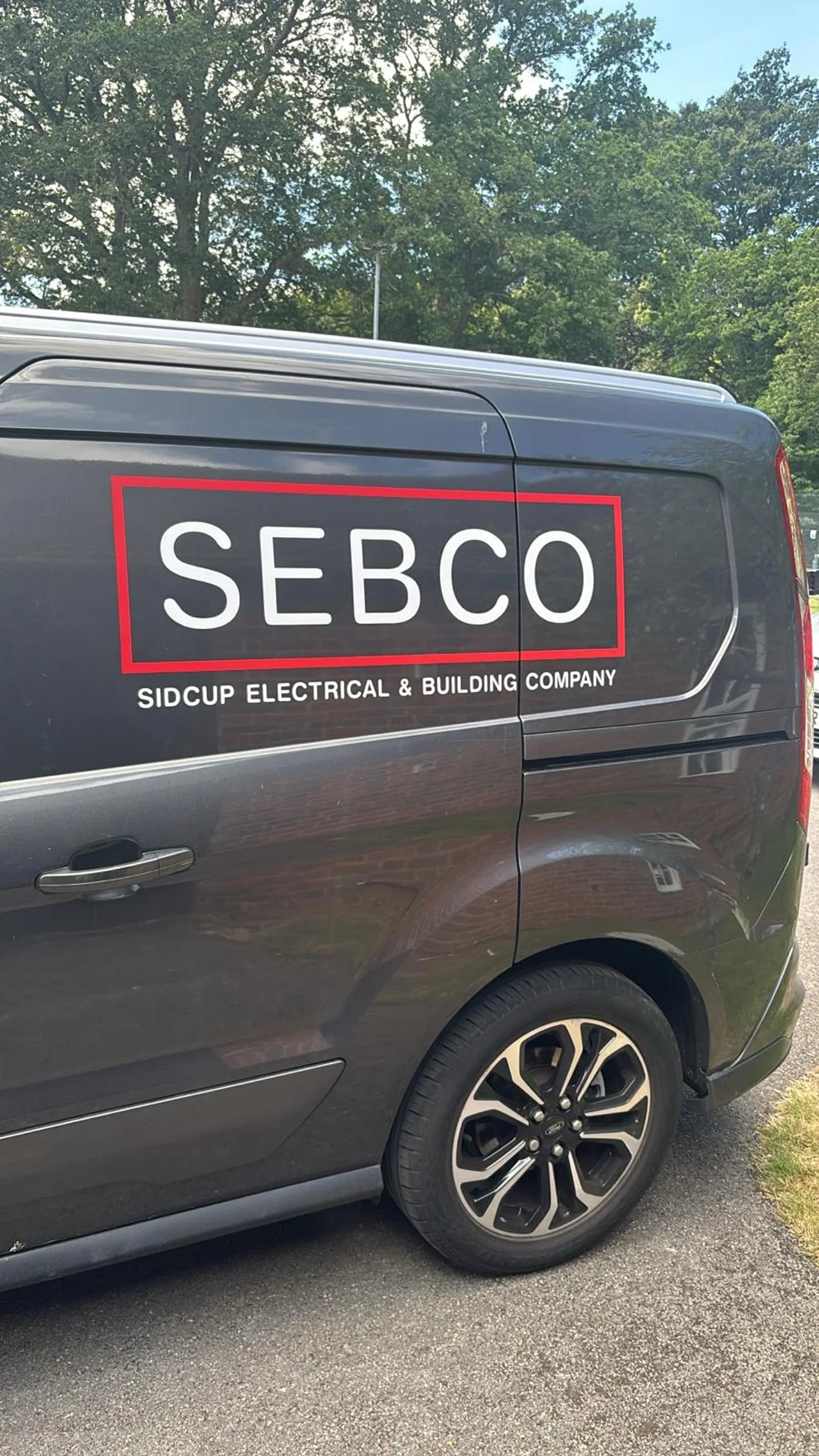 The Sidcup Electrical van in Sidcup, black Ford Transit Connect with the red and white Sidcup Electrical livery